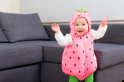 Toddler dressed up as a strawberry and dancing