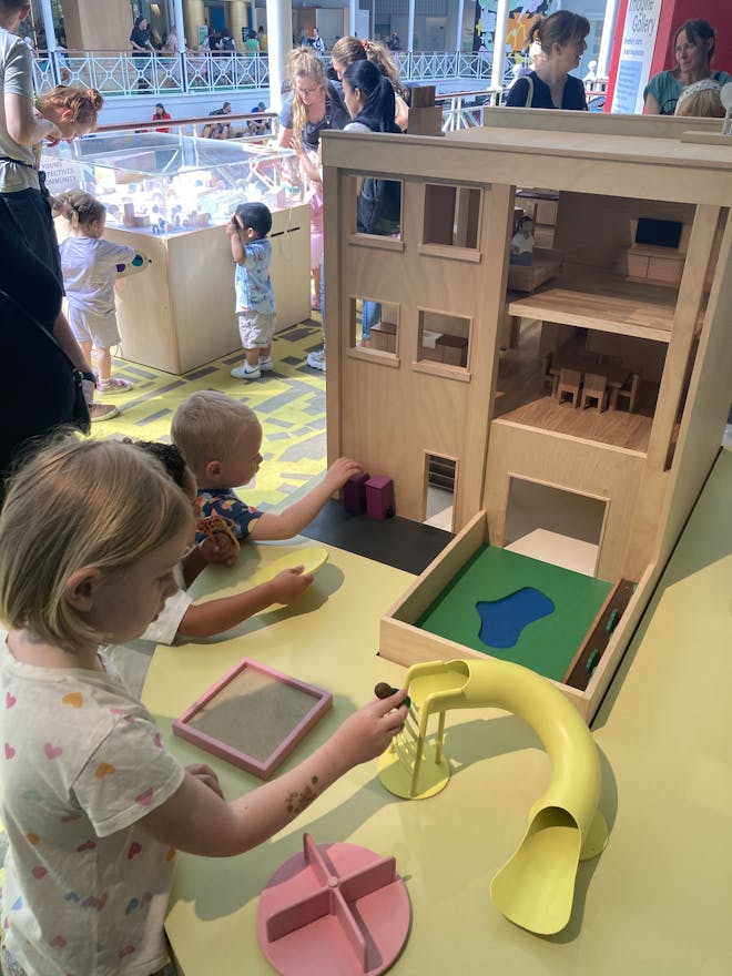 My daughter loved playing with the interactive dolls' house playground in 'The Street'. Image: author's own.