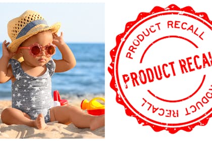 Toddler on beach / product recall sign