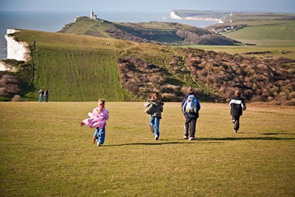 Children running by south downs