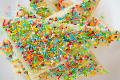 Slices of white bread covered in coloured sprinkles