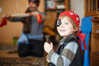 Boy dressed in bandana and eye patch for pirate costume