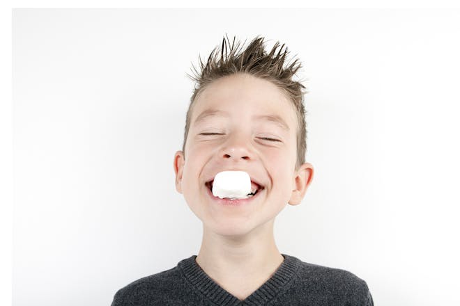 Boy with marshmallow in mouth
