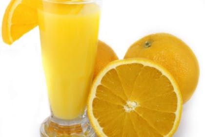 glass of orange juice and oranges