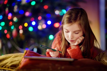 Girl writing New Year's resolutions