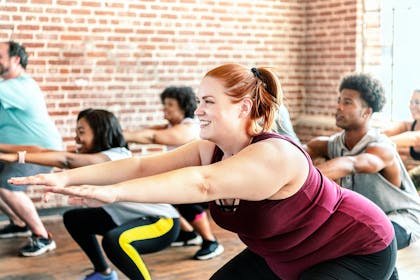 People squatting in a fitness class