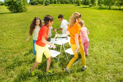 Kids playing musical chairs outside 