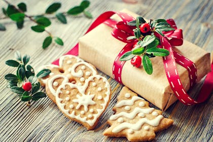 Christmas gift wrapping with ribbon and berries, plus Christmas biscuits
