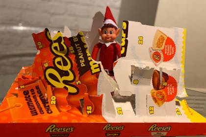 Christmas Elf on the Shelf tears through chocolate Reese's pieces advent calendar