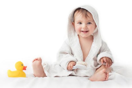 happy baby in dressing gown