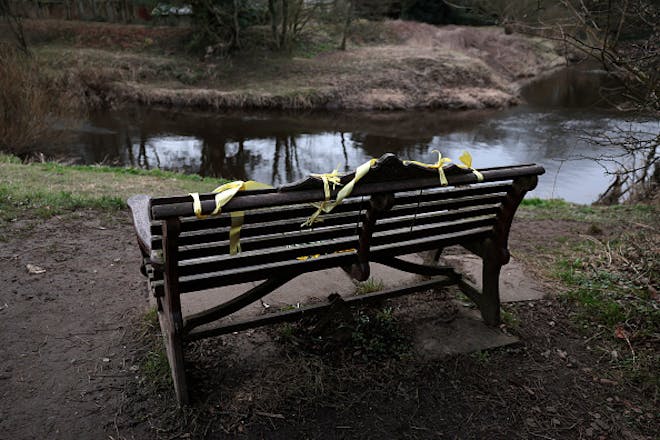 A bench with yellow ribbon draped over it