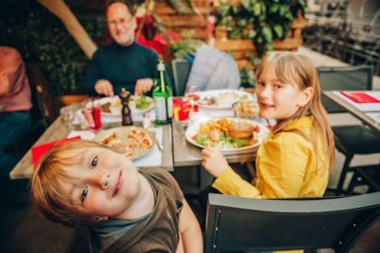 Kids eating outdoors at a restaurant