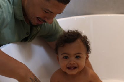 Dad bathing baby as part of bedtime routine