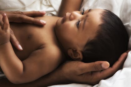 Baby boy in dad's arms