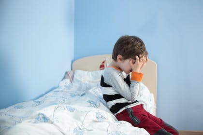Child with special needs awake on bed
