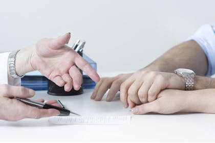 Couple and doctor's hands