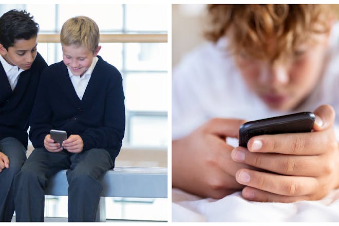 Teenage boys looking at phone in school / teen boy on phone