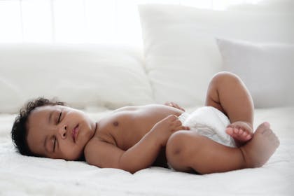 Baby sleeping peacefully wearing nappy