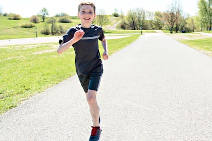 Young boy running in park
