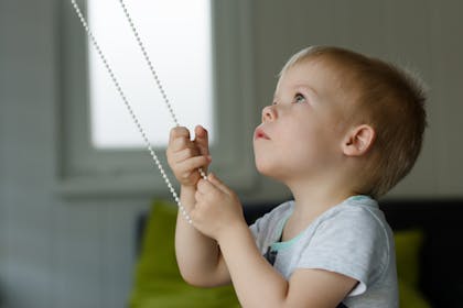 Child pulling blind cord