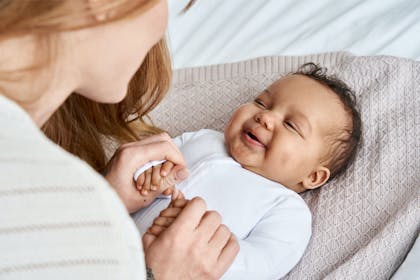 Mother making baby laugh 