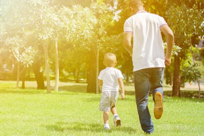 dad chasing child outdoors