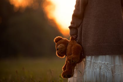 Child holding teddy bear