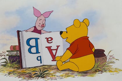 Winnie the Pooh reading a book