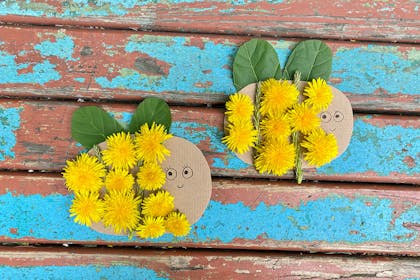 Cardboard bees with dandelions stuck on and leaves for wings