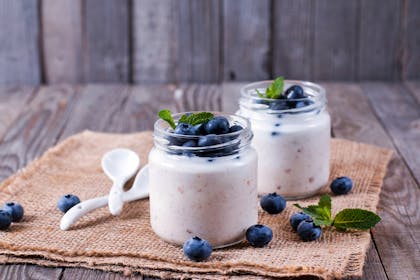 two yoghurt pots topped with blueberries