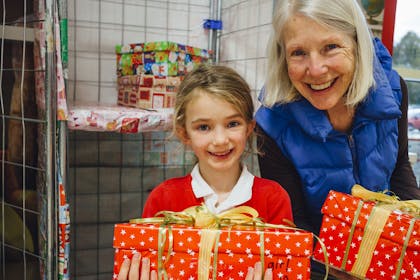 A child and her grandmother volunteering at Christmas