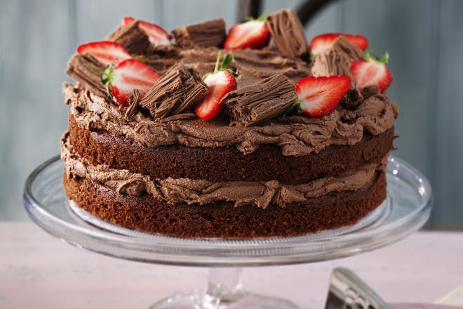 Classic chocolate cake recipe. Chocolate cake with chocolate icing and strawberries.