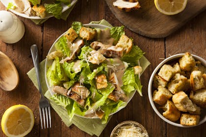 Healthy grilled chicken Caesar salad with cheese and croutons