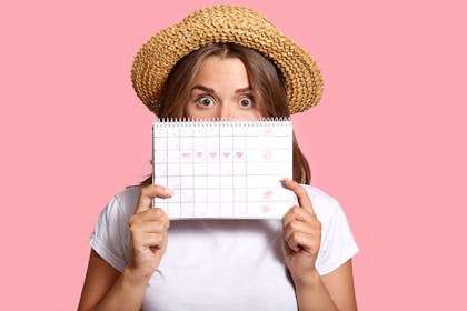 Woman holding up a calendar