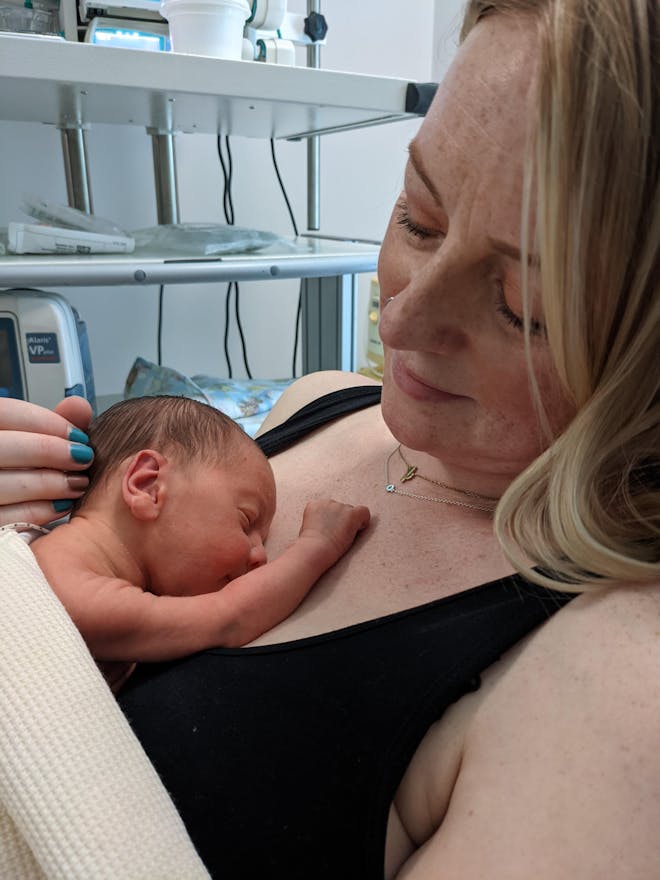 Woman holding premature baby in hospital