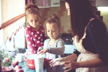 Mum cooking with kids in kitchen