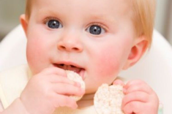 child eating rice cakes