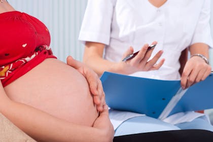 Pregnant woman talking to a midwife