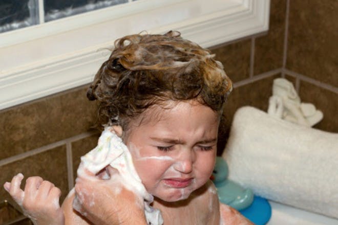 child being washed in bath