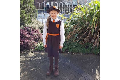 Girl dressed in school uniform for Malory Towers costume