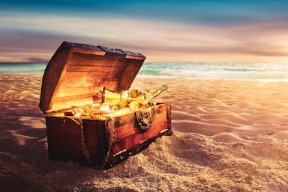 Chest of gold loot on a beach