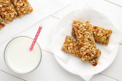 breakfast bars on plate next to glass of milk