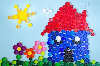 Picture of a house made of coloured bottle tops