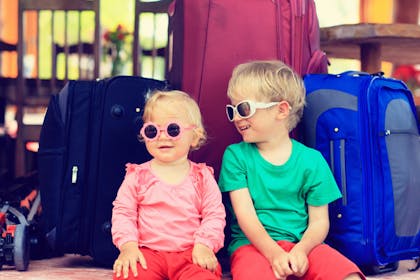 Children in sunglasses with suitcases