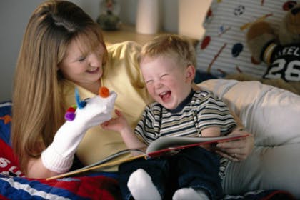 baby and mum laughing at sock puppet