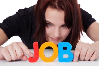 woman holding up colourful letters spelling 'job'