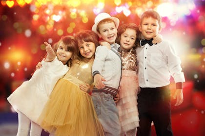 Kids dressed up in smart party outfits on New Year's Eve