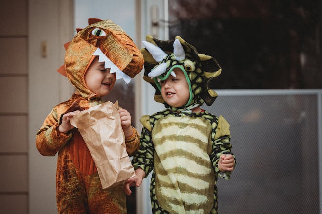 Two toddlers dressed as dinosaurs