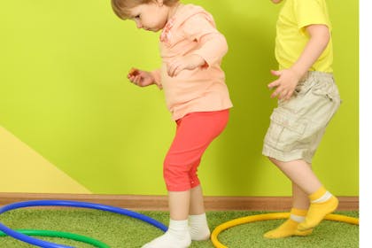 children jumping in hula hoops