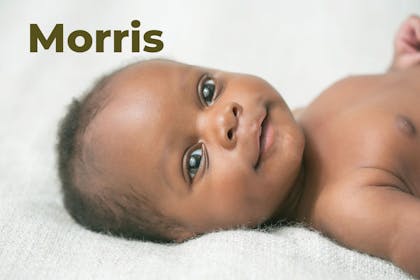 Baby lying on back and smiling. Name Morris written in text